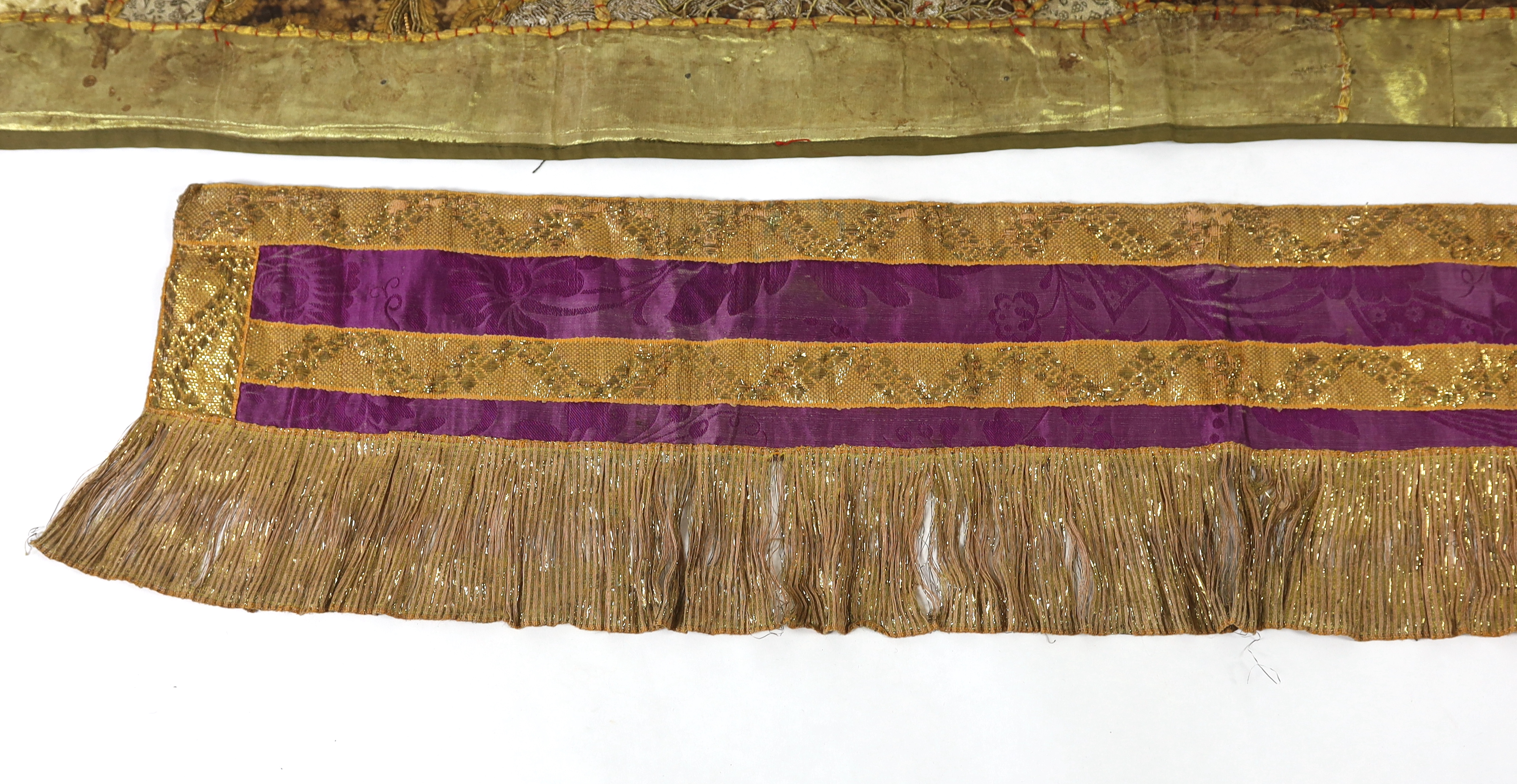 A 20th century Indian patchwork hanging, designed in golds and browns using patchwork batik, beadwork and metallic embroidery, each bordered with thick silk strands bound together, the hanging then bordered with gold met